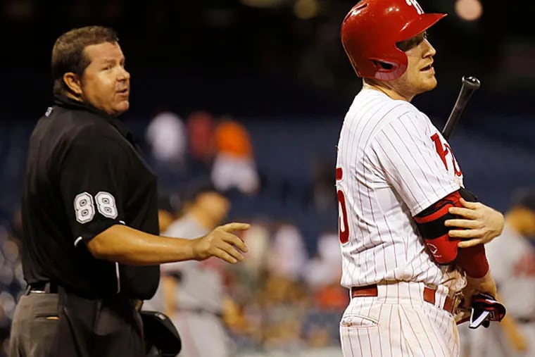 Cody Asche reacts after striking out looking to end the game against the Atlanta Braves.