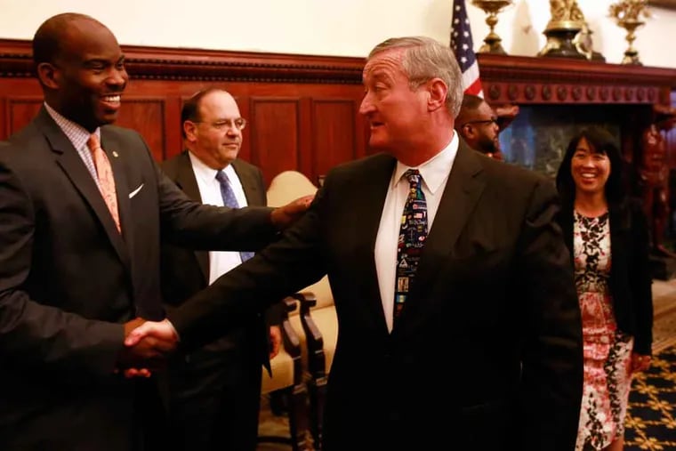 Mayor Kenney shakes hands with City Councilman Derek Green after the soda tax was approved.