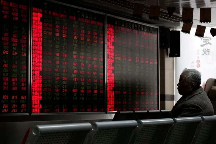 An investor monitors stock prices at a brokerage house in Beijing, Thursday, Jan. 3, 2019.