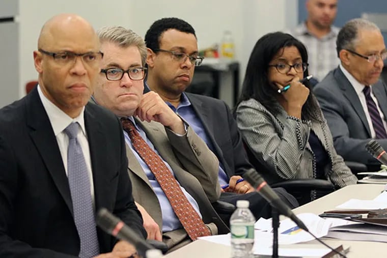 School Superintendent William Hite, left, Board president William Green, second from left and other members of the SRC listen intently to the speakers comment on the proposed budget on Wednesday, April 30, 2014.  ( MICHAEL BRYANT / Staff Photographer )