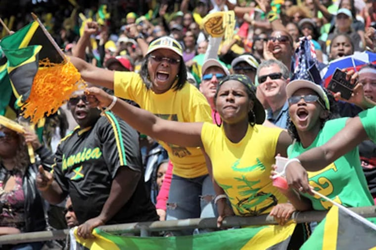 Jacqueline Todd, Ashley Todd and Constance Bingham from St Mary,
Jamaica cheer Jamaican runner Usain Bolt as he runs the final leg to
win the 400 relay at the Penn Relays in April 2010. (Laurence Kesterson / Staff Photographer)