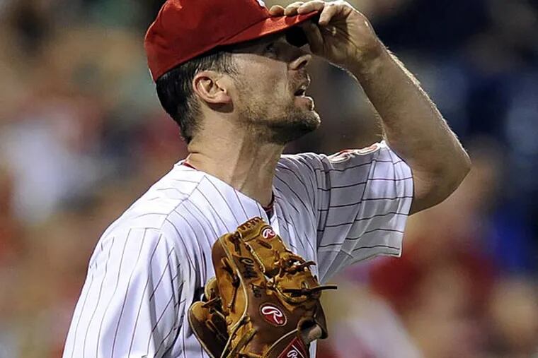 Philadelphia Phillies' Cliff Lee reacts after giving up a run during a baseball game against the Cincinnati Reds on Tuesday, Aug. 21, 2012, in Philadelphia. The Reds won, 5-4. (AP Photo/Michael Perez)