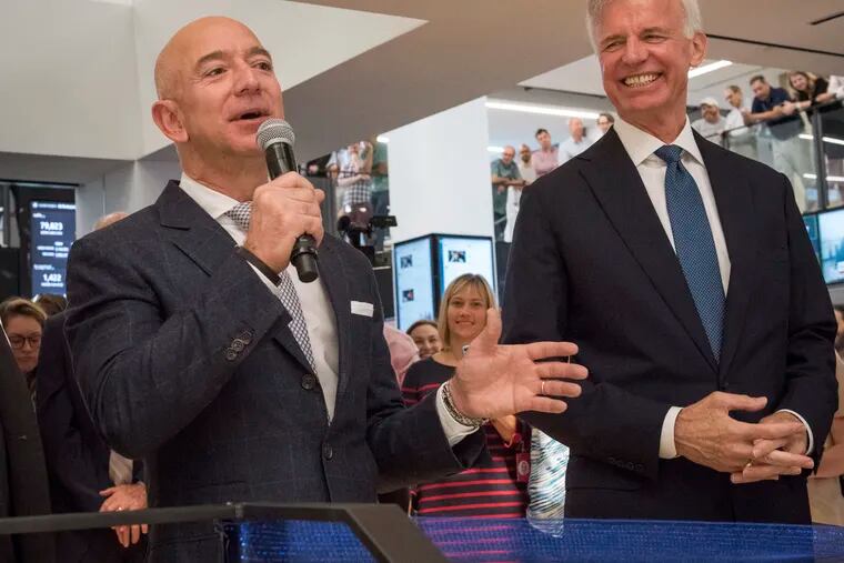 Jeff Bezos, left, makes remarks before a ribbon-cutting ceremony at The Washington Post in September 2018. At right is the Post's publisher, Fred Ryan.