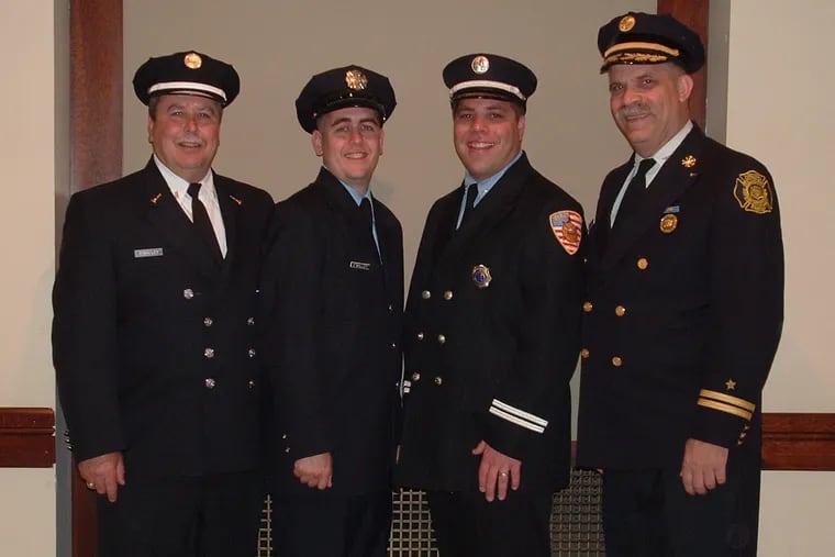 Chief Smith (right) stands with fellow firefighters, from left, Tom O'Malley, his brother-in-law; Shaun O'Malley, his nephew; and his son, James P. Smith Jr.