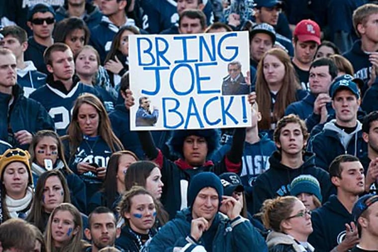 A fan holds up a sign on Saturday calling for the return of Joe Paterno as Penn State's football coach. (Kriston J. Bethel/For the Inquirer)
