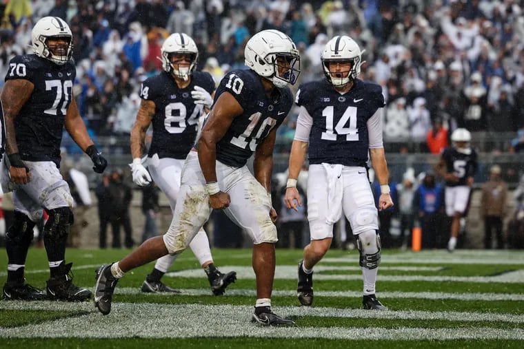 STATE COLLEGE, PA - OCTOBER 01: Nicholas Singleton #10 of the Penn State Nittany Lions celebrates with Sean Clifford #14 after scoring a touchdown against the Northwestern Wildcats during the first half at Beaver Stadium on October 1, 2022 in State College, Pennsylvania.