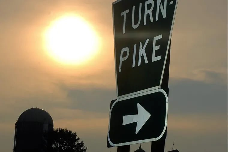 The sun rises on Pennsylvania Turnpike sign.