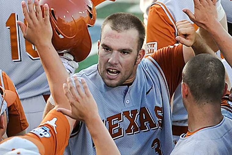 The Phillies selected Texas catcher Cameron Rupp (center) in the third round of the draft.  (Eric Francis/AP)