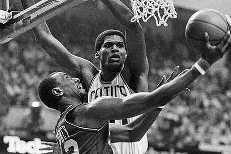 Andrew Toney slips by Boston Celtics Robert Parish for two during National Basketball Association playoff action Sunday night at Boston Garden, May 24, 1982. (AP Photo)