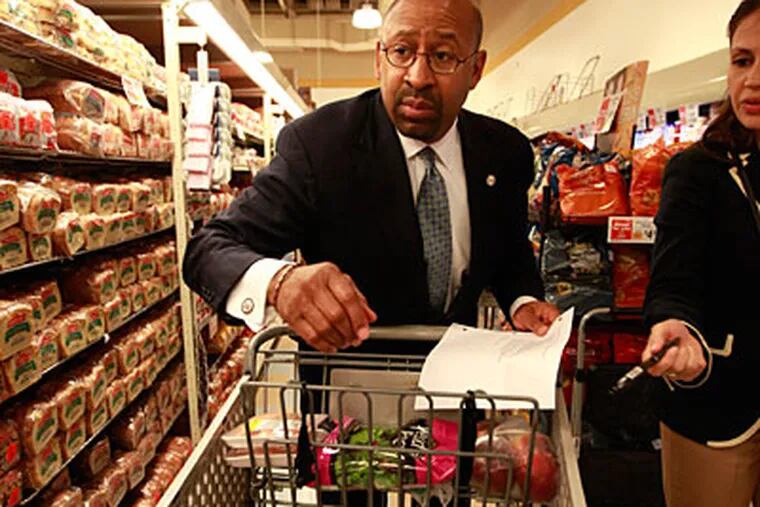 Mayor Michael Nutter attempts to shop for less than $35 for a week's supply of food at Shop Rite on 52nd Street.  (David Swanson/Staff Photographer)