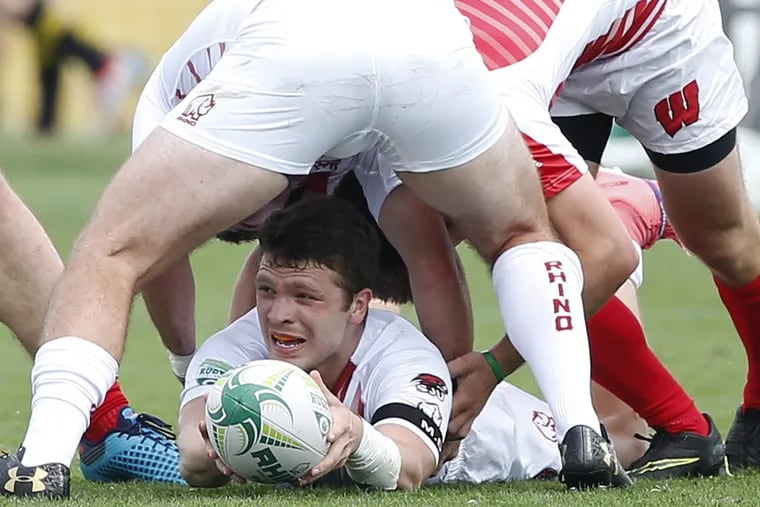 Mikey Hoffman of St. Joseph's winds up under teammate Jimmy Wolfer during pool play against Wisconsin during the Collegiate Rugby Championship tournament Saturday, June 2, 2018, at Talen Energy Stadium in Chester. The teams went on to tie, 17-17. LOU RABITO / Staff 