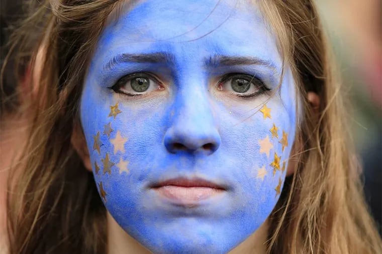A "Remain" supporter, her face painted to resemble the EU flag, walks on Park Lane in London, as protesters marched to Parliament Square to show their support for the European Union.
