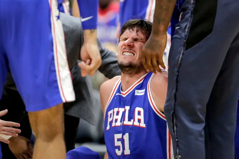 Philadelphia 76ers center Boban Marjanovic (51) winces in pain after being injured in the second half of an NBA basketball game in New Orleans, Monday, Feb. 25, 2019. The 76ers won 111-110. (AP Photo/Scott Threlkeld)