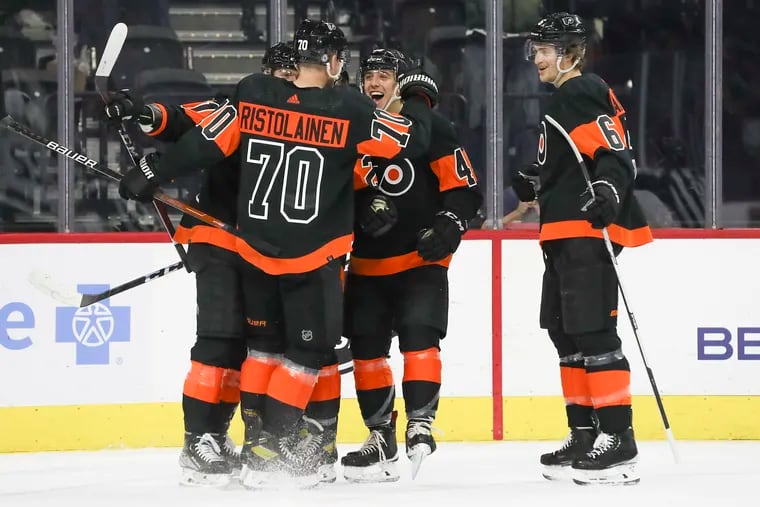 The Flyers celebrate after a goal by center Gerry Mayhew (20) set up by defenseman Rasmus Ristolainen (70) in the first period against the Los Angeles Kings at the Wells Fargo Center on Saturday, Jan. 29, 2022.