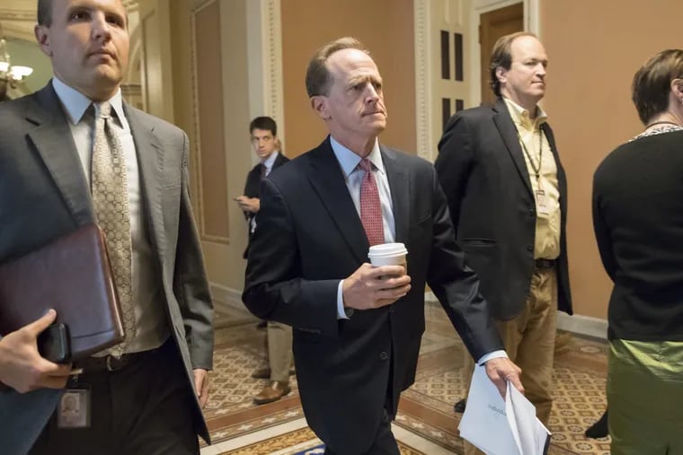 Sen. Pat Toomey, (R-Pa.), strides to a meeting in the Capitol.