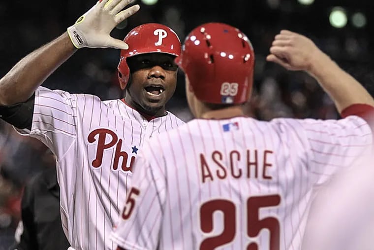 Ryan Howard celebrates his two-run homer against the Marlins with Cody Asche. (Steven M. Falk/Staff Photographer)