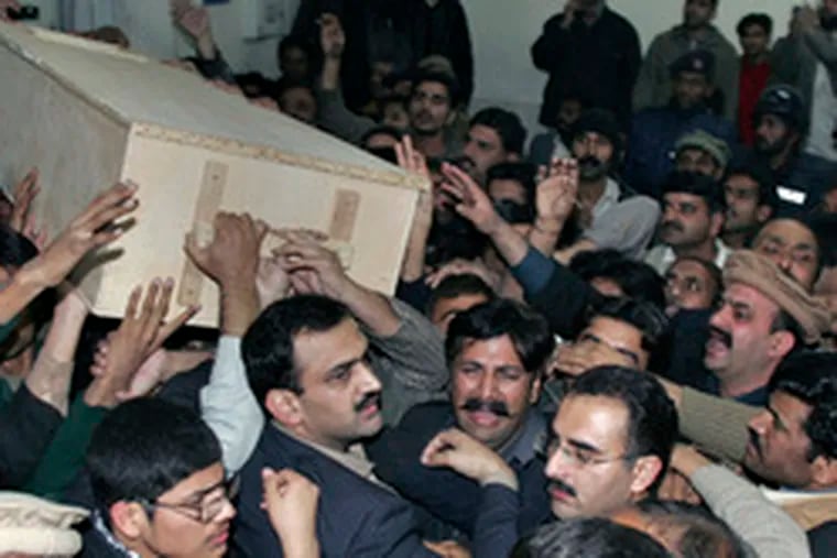 A coffin bearing the body of Benazir Bhutto is carried from a Rawalpindi hospital, where hundreds had gathered. It was later flown, with the former prime minister&#0039;s husband and children, to southern Pakistan, where her family has roots .