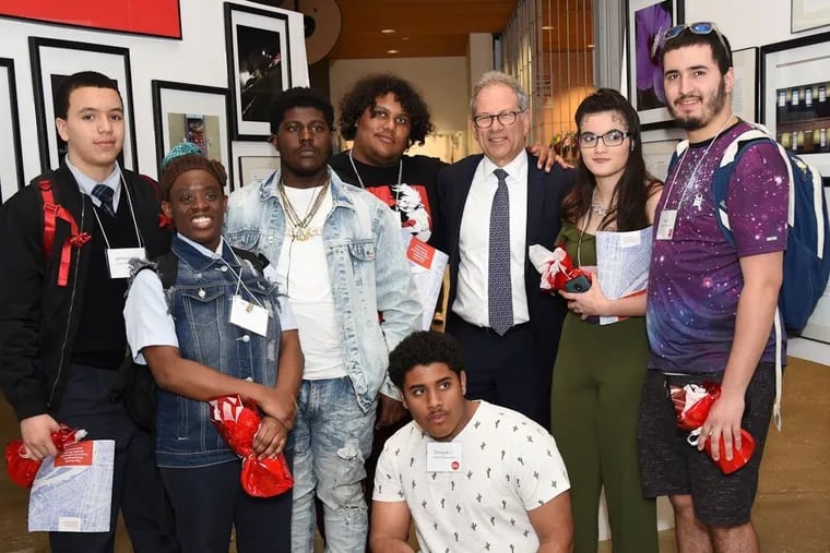 Jack Ludmir, executive director of the Philadelphia Collaborative for Health Equity, poses with Latino students from North Philadelphia who contributed photos of their neighborhood to the collaborative's health assessment report.