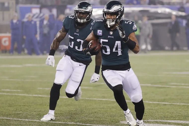 Eagles linebacker Kamu Grugier-Hill runs with the football with teammate Eagles linebacker Nigel Bradham after Grugier-Hill intercepted the football during the first quarter against the New York Giants on Thursday, October 11, 2018 in East Rutherford, NJ. YONG KIM / Staff Photographer