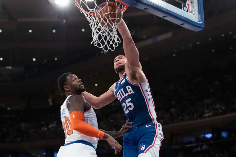 The 76ers' Ben Simmons (25) dunks past the New York Knicks' Julius Randle (30) in the first half of their game on Saturday.