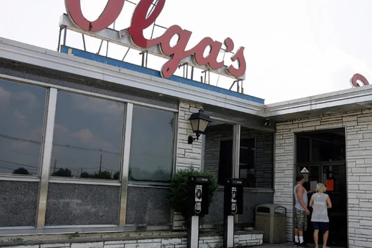 Robert Cox, 22 and Danielle Haverick, 23 from Long Beach, NJ are reading a Notice of Seizure at the door of the Olga's Diner in Marlton, NJ. The famous diner at is closed for non-payment of New Jersey State Tax.