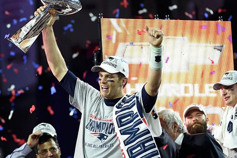 New England Patriots quarterback Tom Brady (12) hoists the Vince Lombardi Trophy after defeating the Seattle Seahawks in Super Bowl XLIX at University of Phoenix Stadium. (Kyle Terada/USA TODAY Sports)