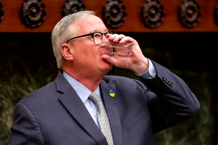 Mayor Jim Kenney takes a drink of Philadelphia city tap water following a press conference Tuesday, Mar. 28, 2023,  after saying, “We can all confidently say the threat has passed. I repeat, all the city’s drinking water is safe to drink.”