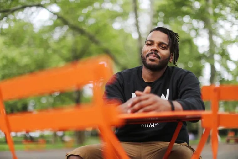 Alexander Harris, a moderator of &quot;West Willy,&quot; a neighborhood-based Facebook group, sits in Clark Park Tuesday May 29, 2018