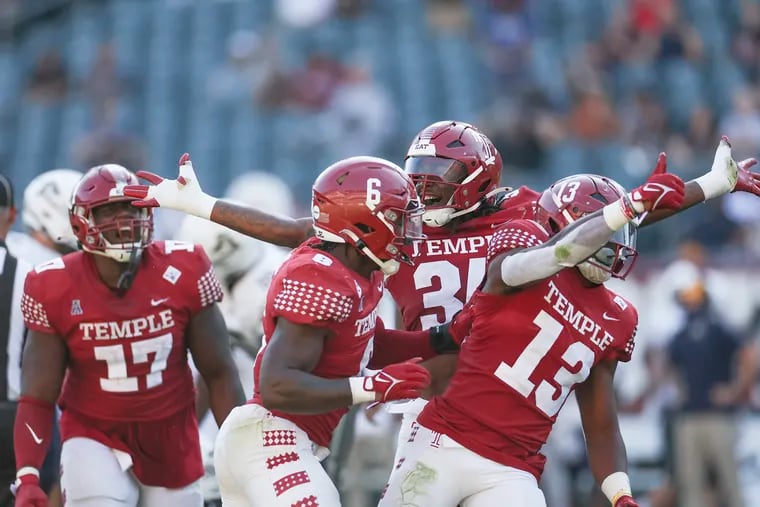 Temple defenders celebrate teammate Layton Jordan (13) after his sack in the fourth quarter of the Owls' season-opening win on Saturday.