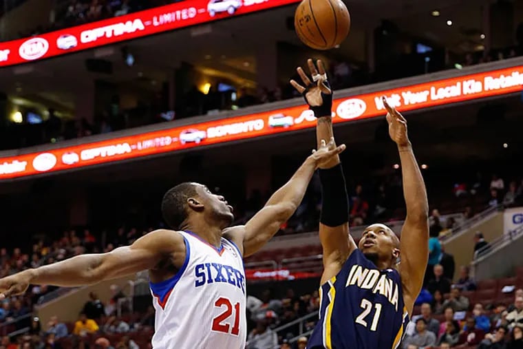 The Pacers's David West, right, goes up to shoot against Philadelphia 76ers's Thaddeus Young during the first half of an NBA basketball game on Friday, March 14, 2014, in Philadelphia. (Matt Slocum/AP)
