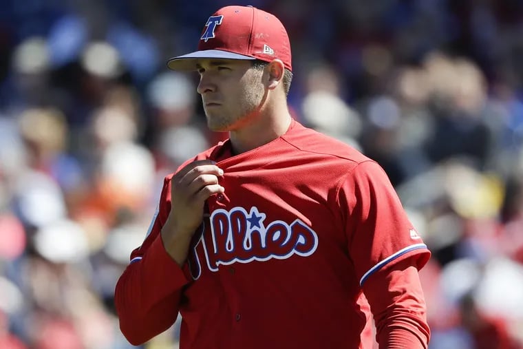 Phillies pitcher Jerad Eickhoff pulls on his jersey after giving up three runs in the third-inning during a spring training game against the Pittsburgh Pirates on Friday, March 9, 2018 at Spectrum Field in Clearwater, FL.