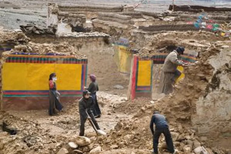 Tibetans demolish houses in Zengshol, a village in the Lhasa River Valley. They are salvaging some materials for houses they will construct about a mile away.