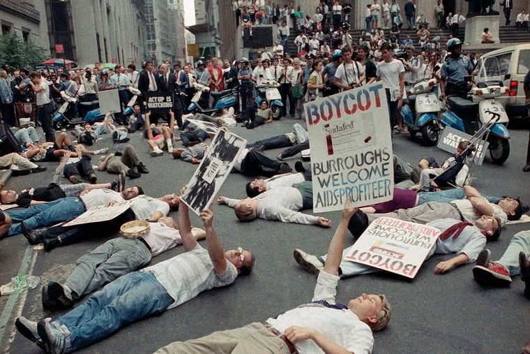In this Thursday, Sept. 14, 1989 file photo, protestors lie on the street in front of the New York Stock Exchange in a demonstration against the high cost of the AIDS treatment drug AZT.
