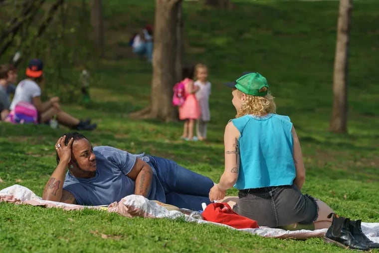 Gabriel Storm (front, left) and Jensen Huff enjoy the beautiful spring weather in Clark Park in West Philadelphia. A recent study found that Philadelphia has the 19th best park system in the nation.
