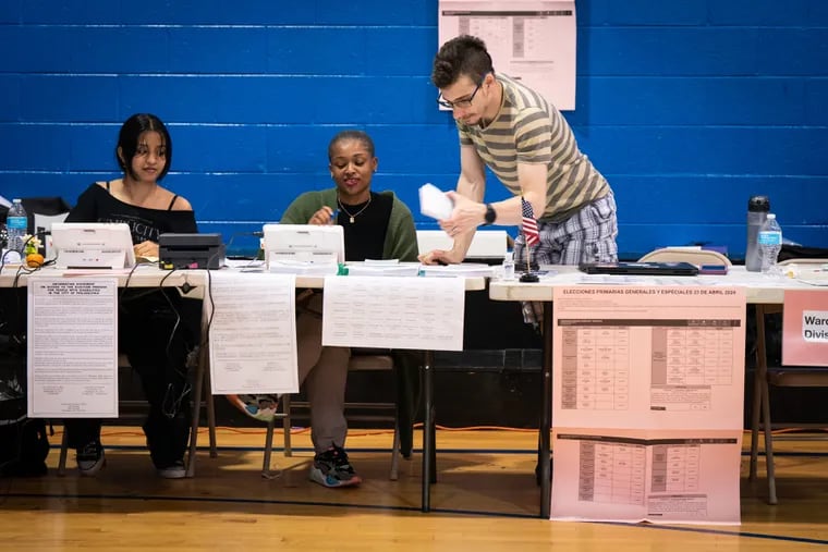 Election volunteers Rasmey Pen, from left, Usrah Hamzie, and Todd Erno, at the Ford PAL Recreational Center in South Philadelphia. Poll workers say they didn't have a whole lot to do.