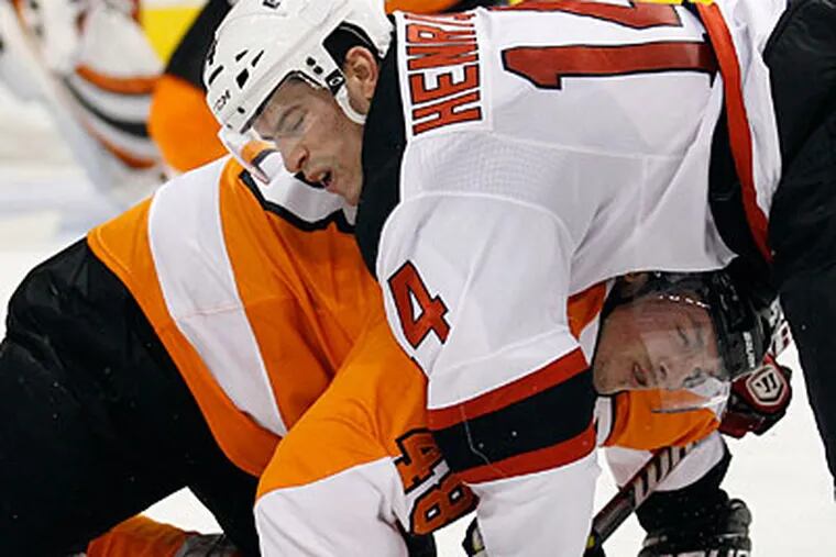 Flyers center Danny Briere gets taken down during a second period face off against the Devils' Adam Henrique. (Yong Kim/Staff Photographer)