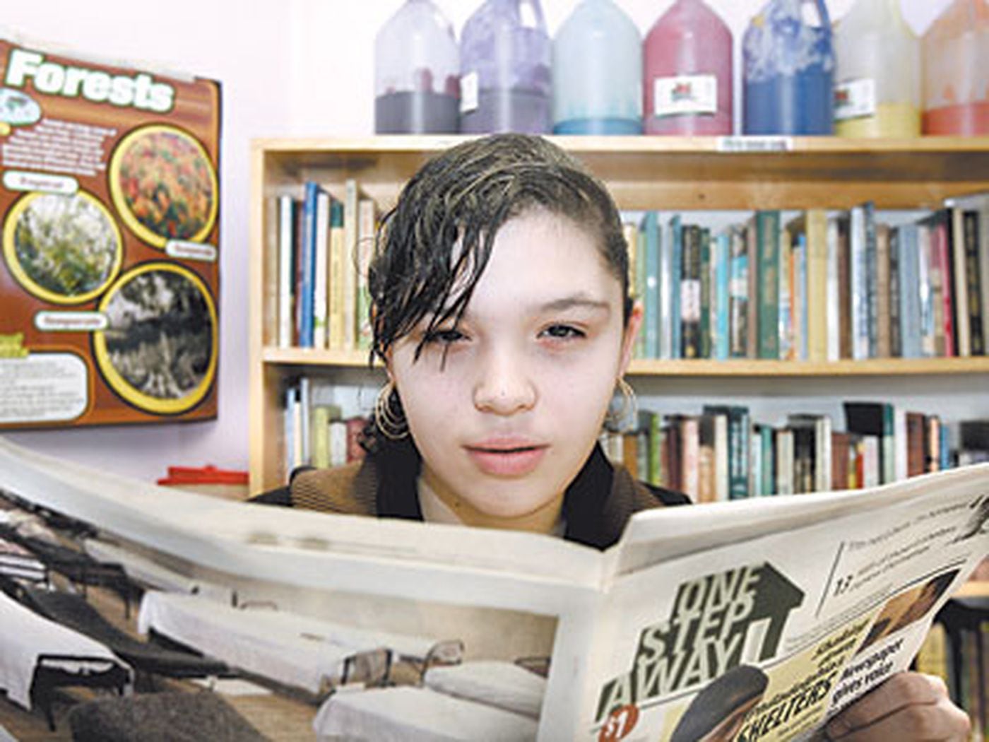 Thirteen-year-old Stephanie Bermudez holds a copy of One Step Away in the library of Woodstock Shelter in North Philadelphia in 2009. ( Bonnie Weller / Staff Photographer )