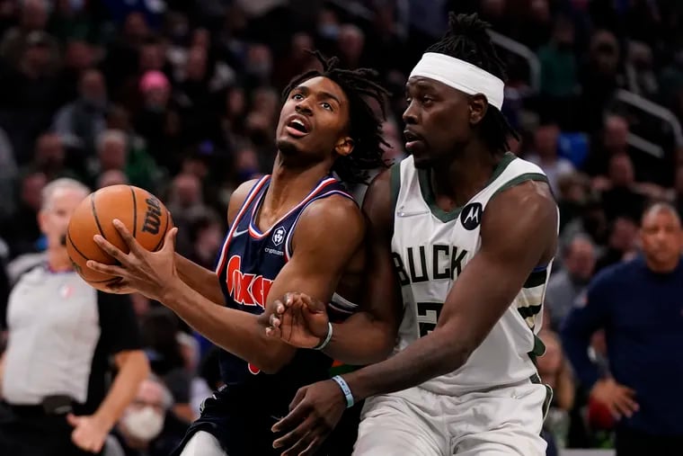 The Sixers' Tyrese Maxey drives past the Bucks' Jrue Holiday in the first half of Thursday's game. Maxey had 14 points in the second quarter.