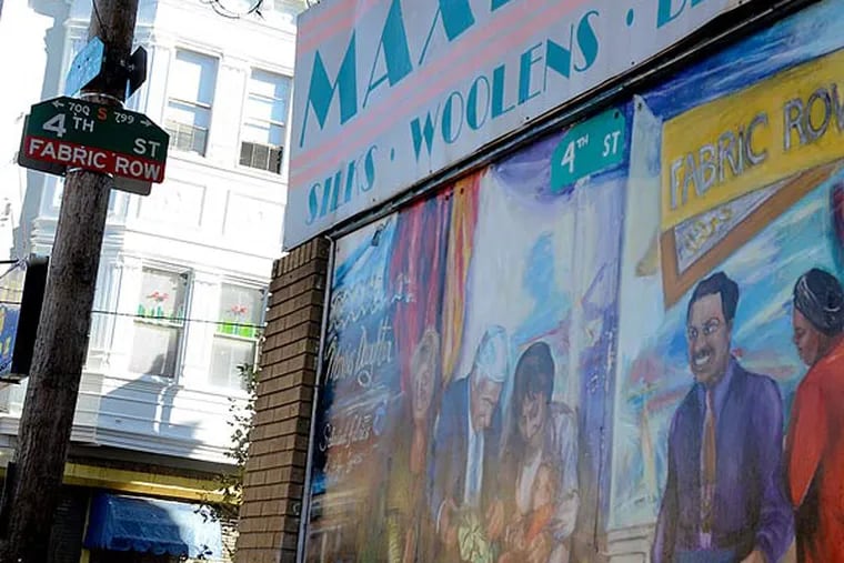 A mural and 4th Street sign on the side of Maxie's Daughter fabric shop on Philly's 4th Street corridor. (Tom Gralish/Staff Photographer)