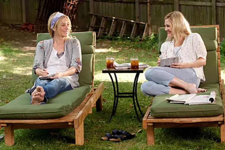 Drew Barrymore (right) plays half the couple separated by geography and Christina Applegate is her sister in "Going the Distance."