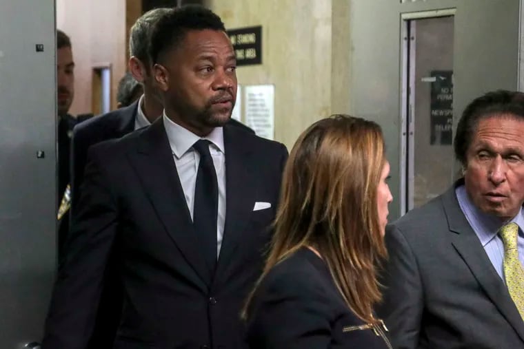 Cuba Gooding Jr., left, follows his legal team from court after he pleaded not guilty to sexual misconduct charges.
