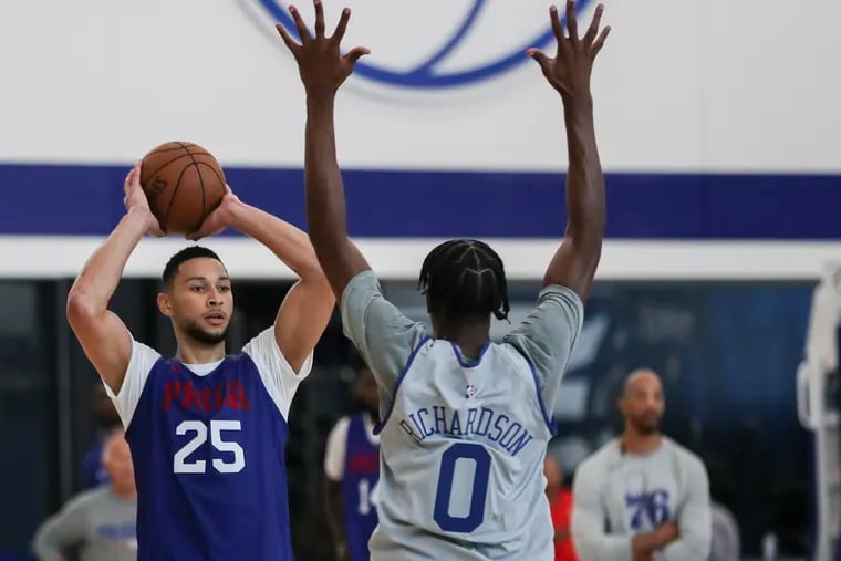 Ben Simmons (25) looks to pass the ball over Josh Richardson during a scrimmage at practice.