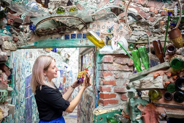 Emily Smith, executive director of Philadelphia's Magic Gardens on South Street, holds an artwork made by Concepcion Aguilar, which she collected in Oaxaca Mexico. The work will be added to the garden installation, which features huge swirls of mosaics, glass and mirrors.