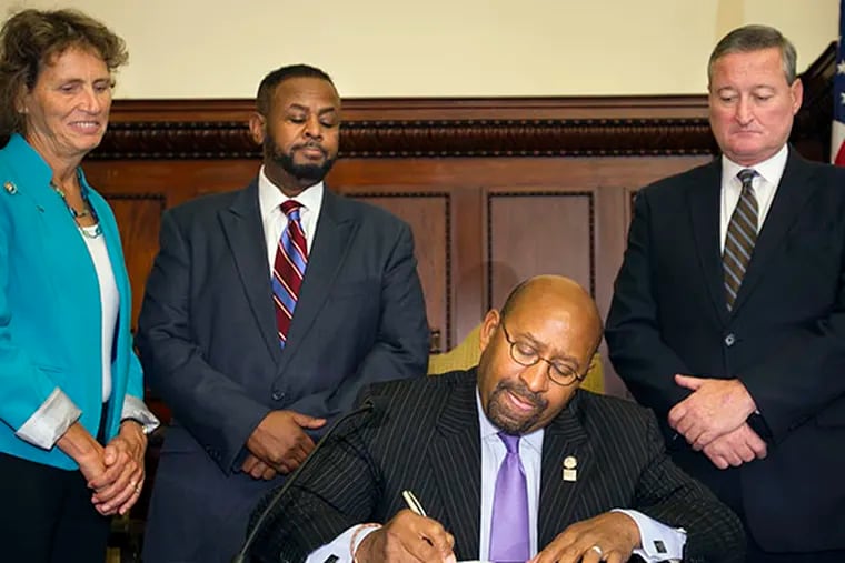 Philadelphia Mayor Michael Nutter signs City Council legislation and executive order decriminalizing 30 grams or less of marijuana on Wednesday, October 1, 2014. In background from left are Cathy Carr, executive director Community Legal Services; Councilman Curtis Jones; and Councilman James Kenney. ( ALEJANDRO A. ALVAREZ / STAFF PHOTOGRAPHER )
