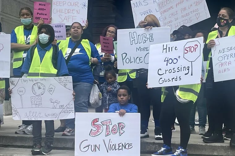 Staff, students and parents from the Mastery Charter network rally outside City Hall Thursday. Dozens gathered to call on the city to fill 400 crossing guard vacancies, hire more police and 911 operators