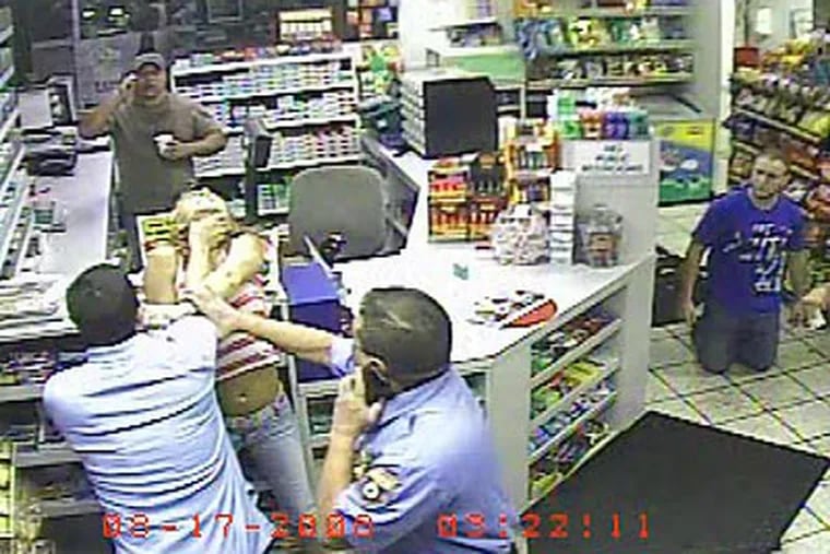 Surveillance images from store cameras show a confrontation last August in a Northeast Philly Lukoil store between Agnes Lawless and Police Officer Alberto Lopez. This frame shows the officer's son using a throat-hold on the woman.