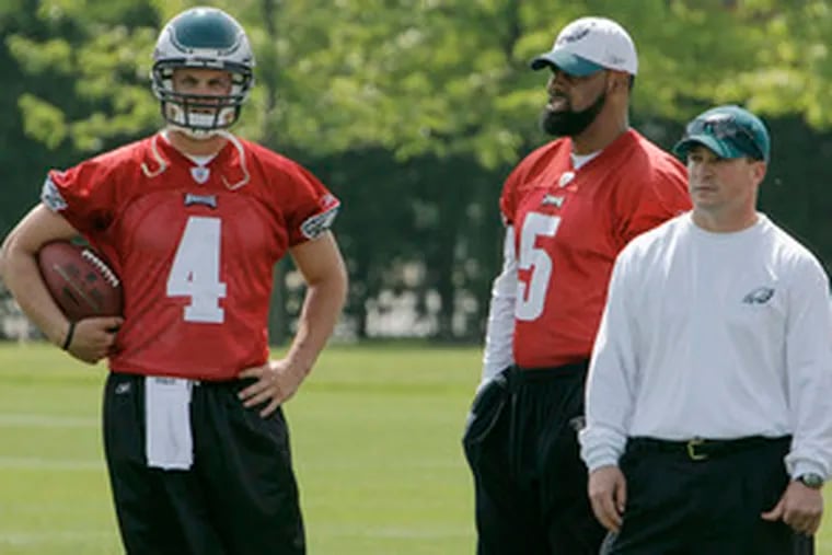 New backup quarterback Kevin Kolb (left) and starter Donovan McNabb stand by with a trainer at the Eagles&#0039; post-draft minicamp at the NovaCare Complex at Broad Street and Pattison Avenue.