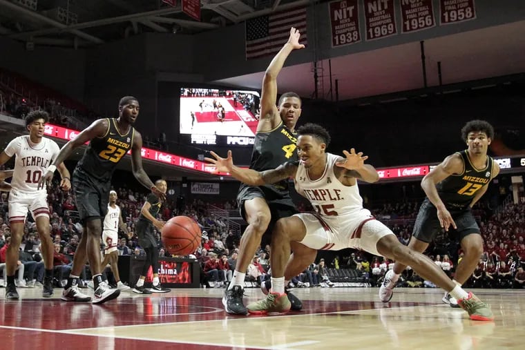 Nate Pierre-Louis, center, of Temple loses the ball after dribving down the lane against a group of  Missouri defenders at the Liacouras Center on Dec. 7, 2019. L-R: Jeremiah Tilmon (23), Javon Pickett, (4), and Mark Smith (13) of Missouri.