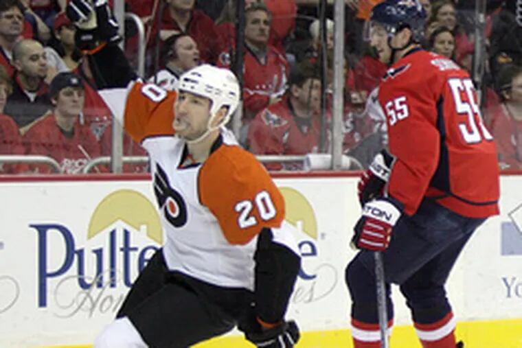 Flyers&#0039; R.J. Umberger skates past Capitals&#0039; Jeff Schultz while celebrating his first-period goal.