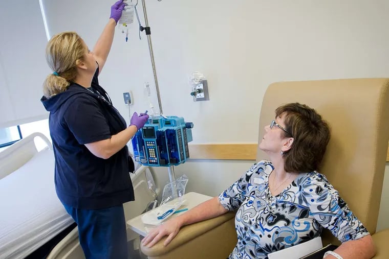 Theresa Slayton, who has a disease so rare only about 12 people in the U.S. are stricken each year, watches Nancy Tierney start an IV.